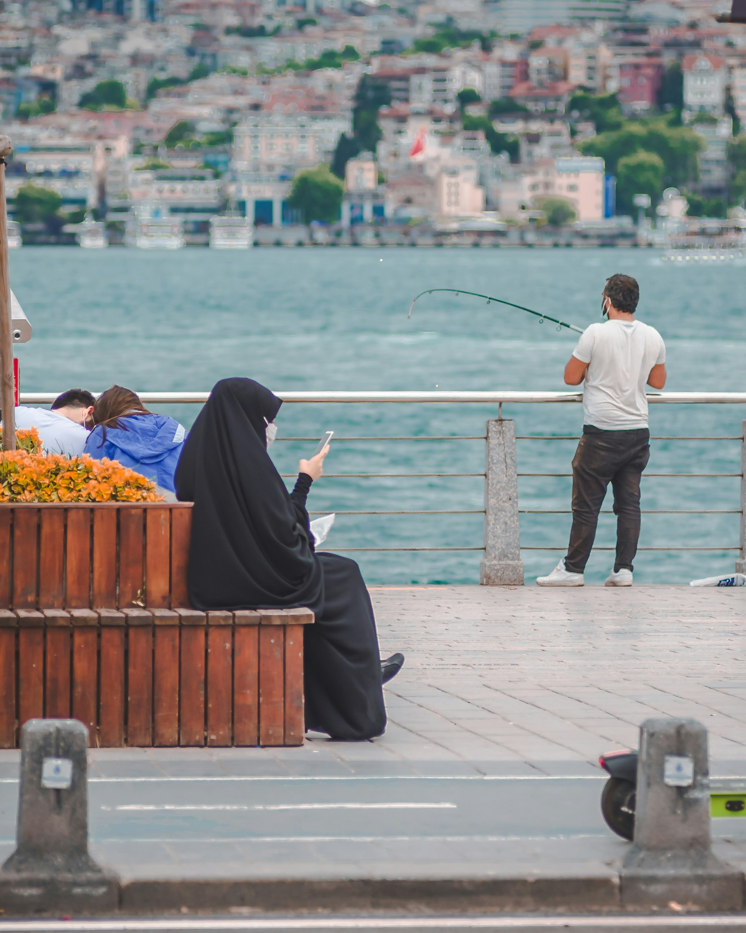 man and woman sitting on dock during daytime